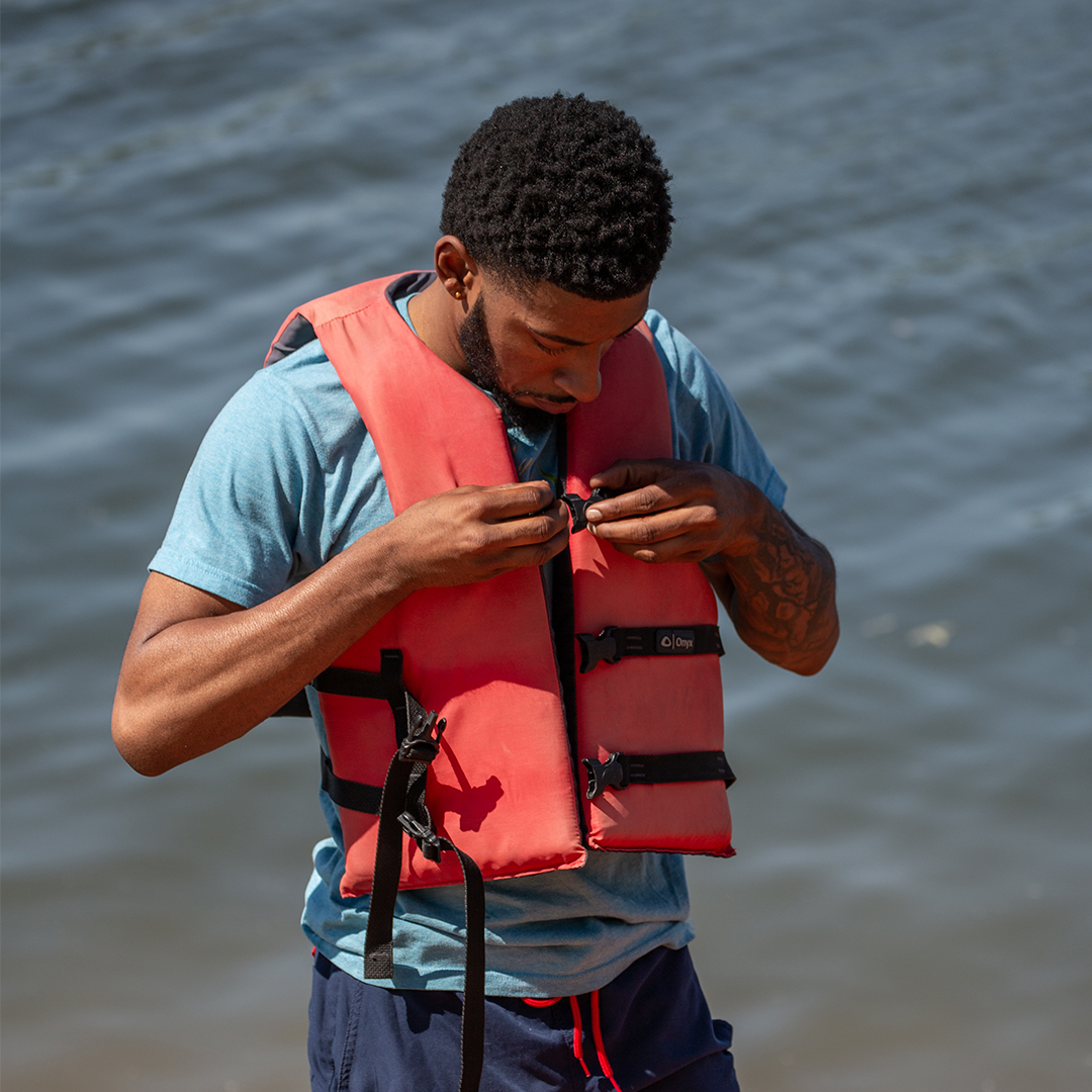 young man putting on a life jacket